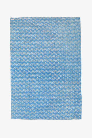 Blue fabric with white floral pattern on a white background
