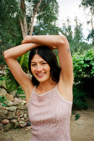 Woman with arms raised in a natural setting