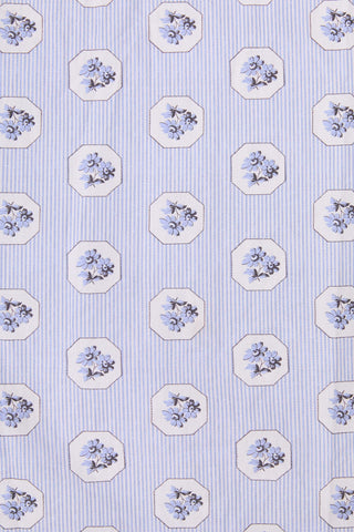 Patterned fabric with small floral designs on a striped background