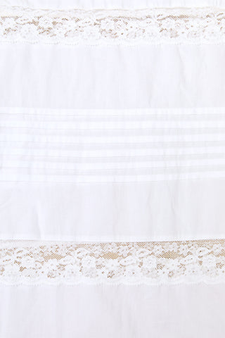 White fabric with lace trim at the top and bottom