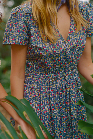Person wearing a floral dress with a blurred background