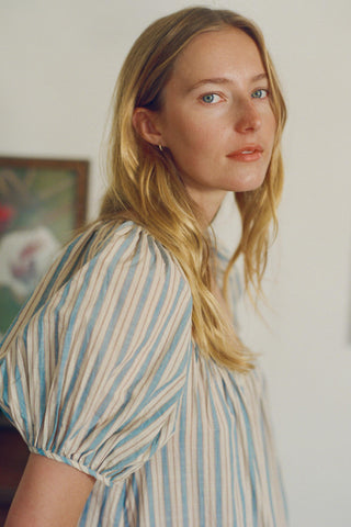 Woman wearing a striped dress with a blurred background