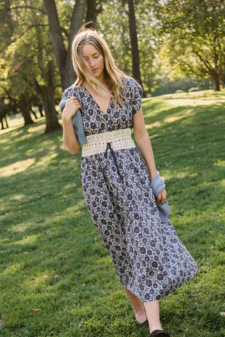 Woman in a floral dress standing in a park