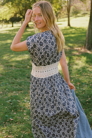 Woman in a floral dress standing in a park