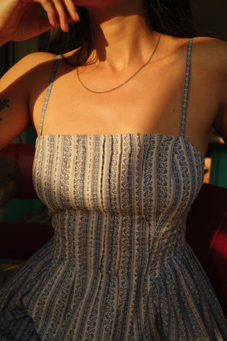 Woman wearing a patterned dress with a blurred background