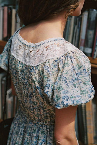 Person wearing a floral dress with a blurred background