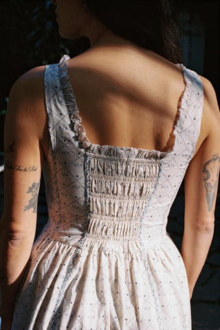 Smocked back of a dress with a square neckline and sleeveless