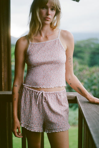 Woman wearing a matching top and shorts set with a scenic background