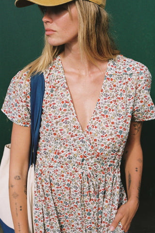 Woman wearing a floral dress with a green background