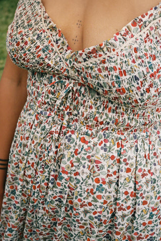 Close up detail of the floral and fruit print on a persons chest