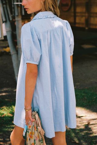Woman wearing a light blue dress with a blurred background