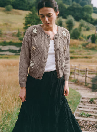 Woman wearing a patterned cardigan in a natural setting