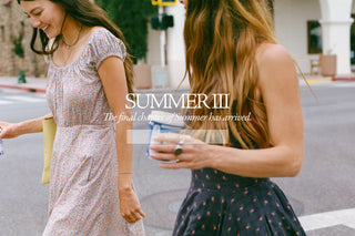 Two women walking on a city street wearing patterned summer dresses, with overlaid text reading 'SUMMER III' and 'The final chapter of summer has arrived.'.
