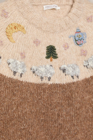 Knitted sweater with embroidered sheep, tree, moon, and teapot design.