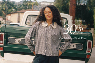 Woman in a checkered dress on a rooftop with promotional text for a Mother's Day offer.