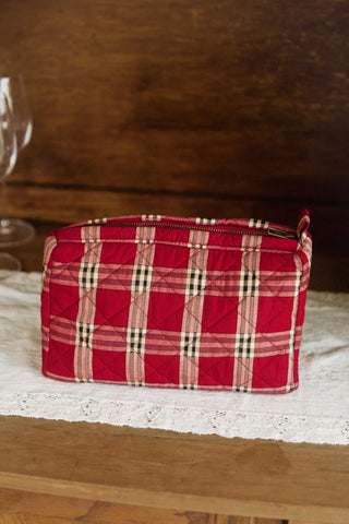 Red plaid fabric basket on a wooden surface