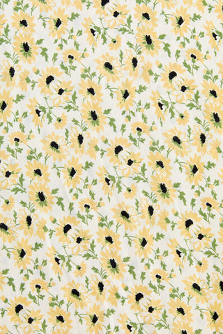 Pattern of yellow flowers with green leaves on a white background