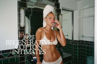 100% regenerative cotton intimates copy over a woman supping a drink in a bathroom in her underwear