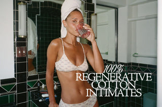 100% regenerative cotton intimates copy over a woman supping a drink in a bathroom in her underwear