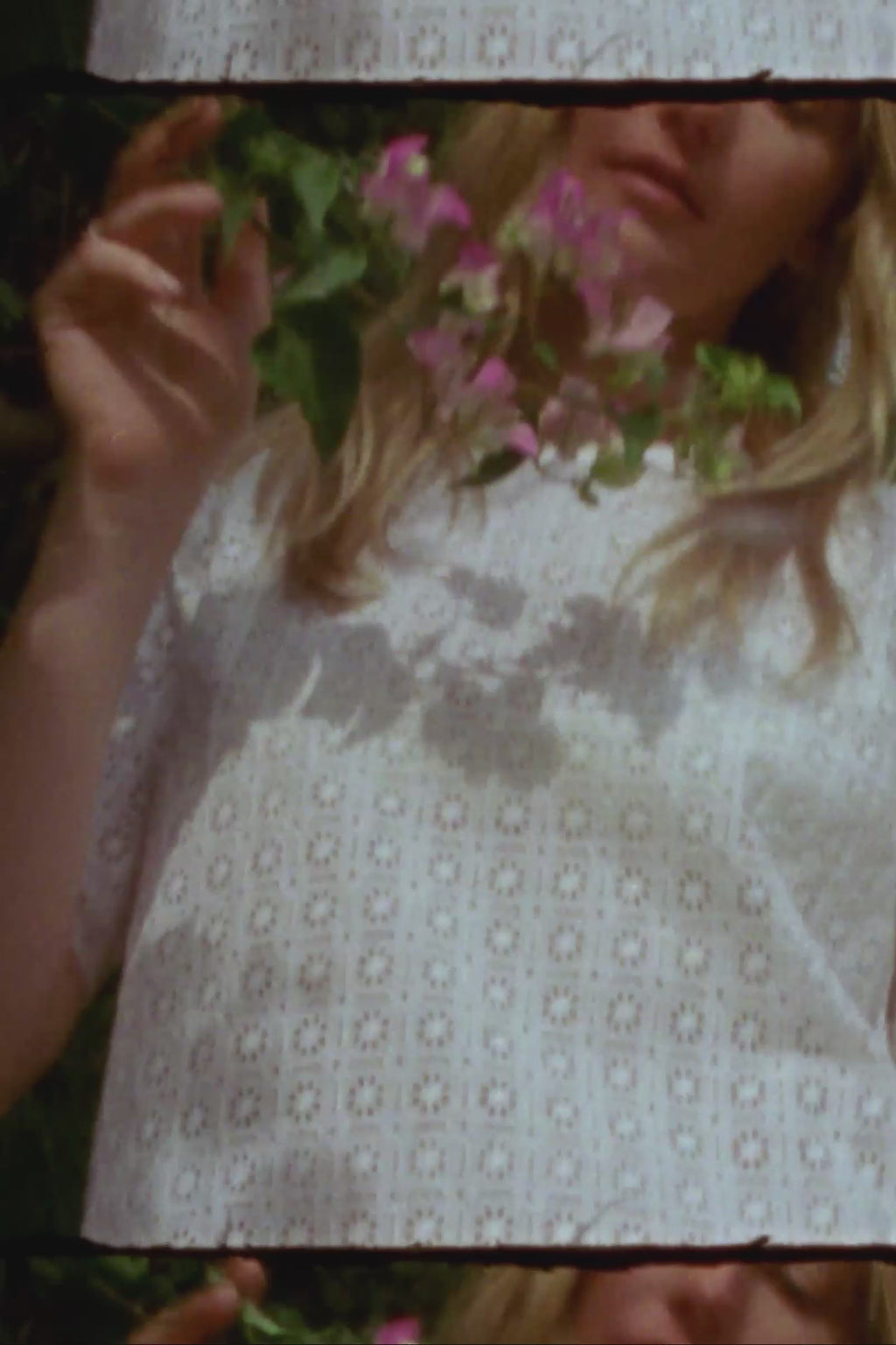 Woman wearing a white lace tunic in a garden setting