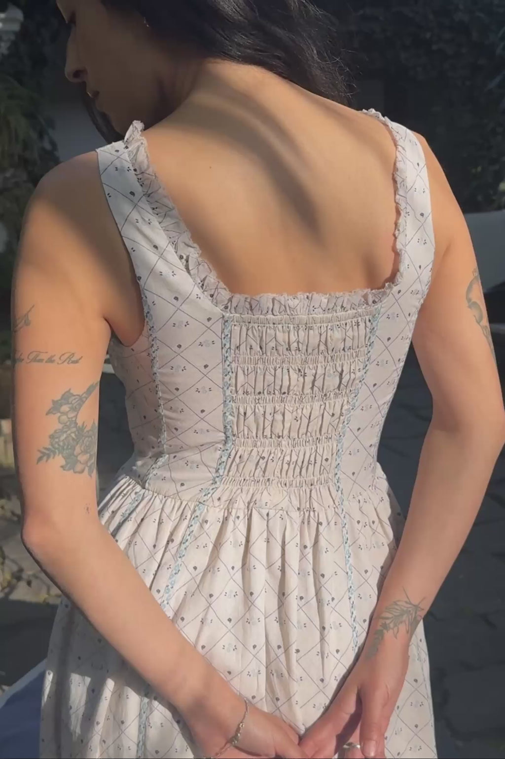 Close up shots of the smocked back and front of a light dress