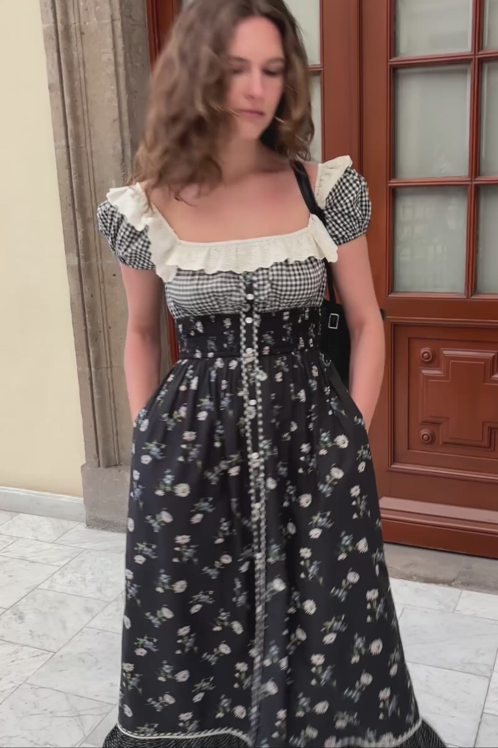 Woman wearing a black and white checkered top with a floral dress, 