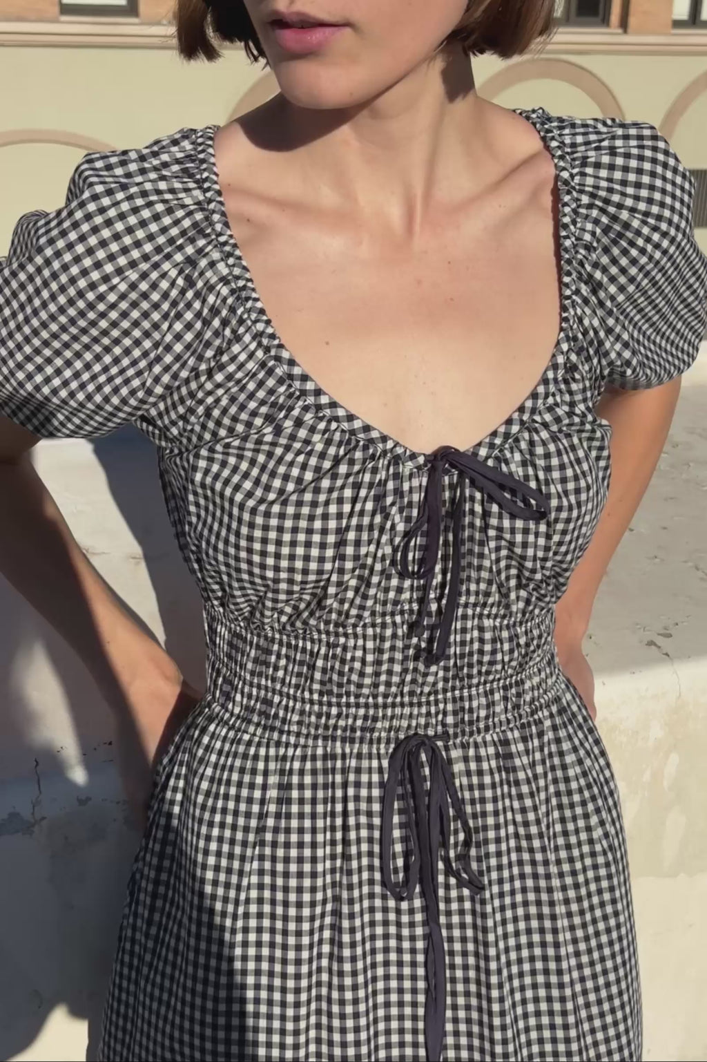Woman wearing a blue and white checkered dress 